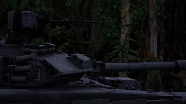 Armored turret undergoing field camouflage test, paint patterns blended with leaf cover, closeup showing texture and finish, experimental field study mood