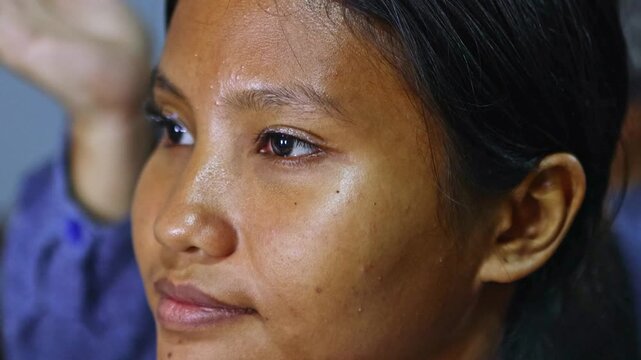 Professional makeup artist applying false eyelashes