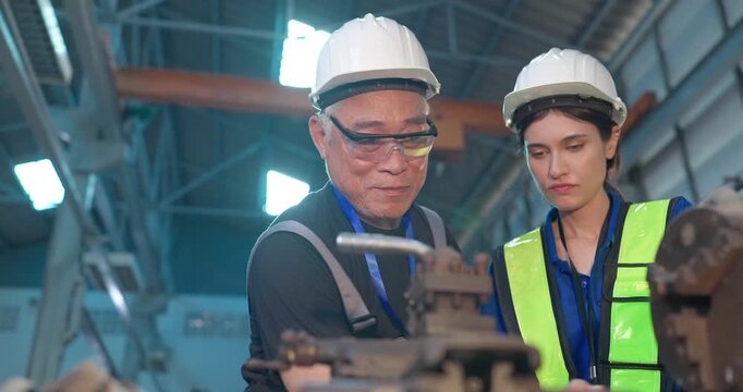 Father passes down machine know-how to his daughter in a family factory, guiding succession, workshop skills and leadership transition through hands-on manufacturing training.
