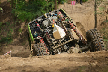 Fototapeta premium Red Pickup off road 4WD spin mud dirty track on mountain hill. 