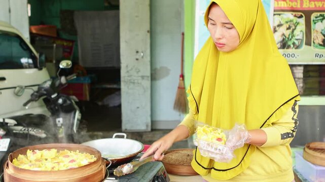 Muslim street food vendor preparing steamed siomay dumplings