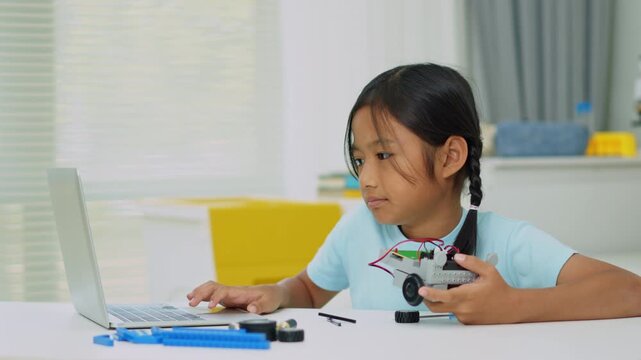 Young girl having fun working on a robot design
