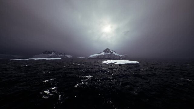 Brooding ice shelf with ominous sky, heavy cloud casting shadow over rough sea, stark cliff faces and fractured ice, cold palette, sense of isolation