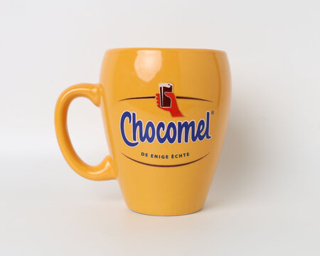 The Hague, Netherlands - March 19, 2026: Chocomel Branded Yellow Mugs Stacked on White Background