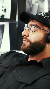 Man, tired and security guard sleeping in control room for shift fatigue, overworked or safety threat. CCTV monitor, exhausted worker and bored in office with nap, misconduct and surveillance breach