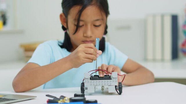 Young girl having fun working on a robot design