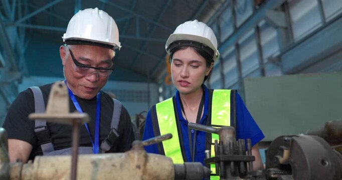 Father passes down machine know-how to his daughter in a family factory, guiding succession, workshop skills and leadership transition through hands-on manufacturing training.
