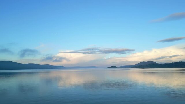 Drone footage captures the stunning natural beauty and historical significance of Bafa Lake Nature Park in Turkey. The aerial perspective showcases the serene waters of Bafa Lake nestled amidst rugged