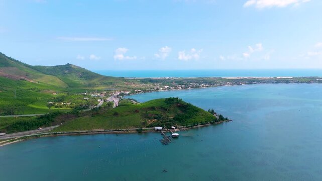 Aerial view of the oyster farm, green mountains, and clear blue waters create a striking contrast of colors and textures, tt. Lang Co, Hue, Vietnam.