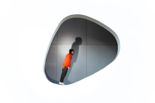 Man posing in modern geometric space in Barcelona with minimalist style