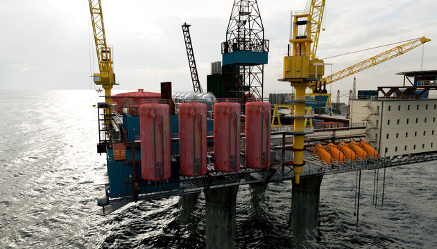 Modern offshore oil rig with cranes and equipment in the sea