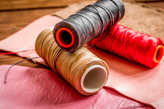 leather craft instruments on wooden background close up