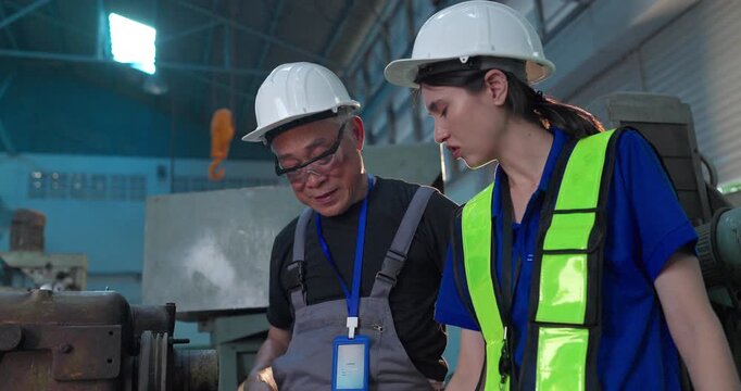 Father passes down machine know-how to his daughter in a family factory, guiding succession, workshop skills and leadership transition through hands-on manufacturing training.
