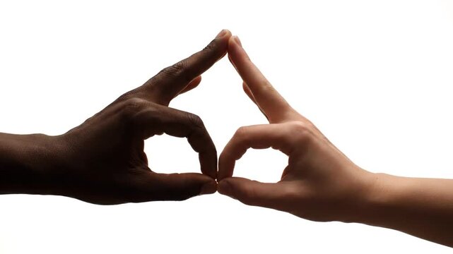 Two hands of different skin tones come together against a white background, touching fingers to create a symmetrical symbol of unity and connection.