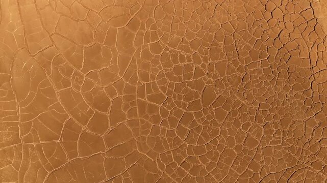 Aerial view of the unique cracked red mud patterns and dry mineral deposits in the mining landscape of Minas de Riotinto, Andalusia, Spain.