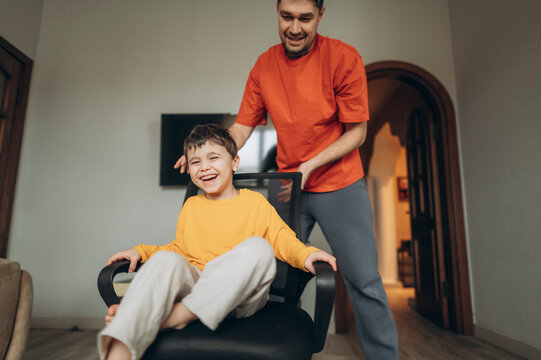 Father and son fooling around and laughing together at home