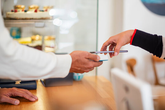 Detail of mobile payment with credit card in caf� setting