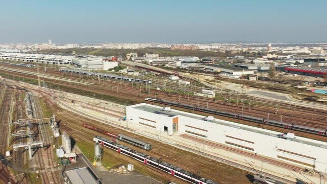 Aerial view of multiple trains and railway tracks with a white building, showcasing the SNCF Voyageurs infrastructure, Bobigny, Ile-de-France, France.