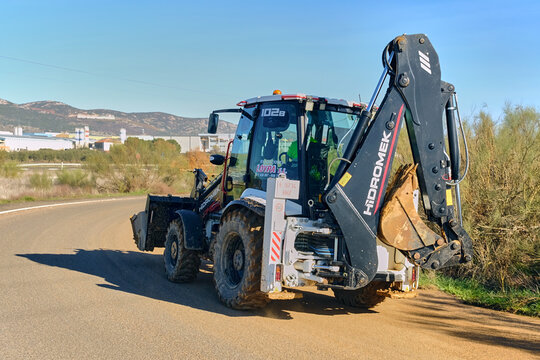 Infrastructure Development In Spain Backhoe Loader On Road In Puertollano Castilla La Mancha Construction Equipment For Public Works Projects And Civil Engineering