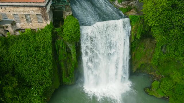 Town of Liri Island - Waterfall and Boncompagni Viscogliosi Castle - Drone view, moving away from waterfall (closeup)
