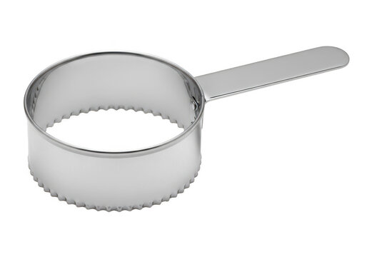 Stainless steel measuring spoon resting on a flat surface