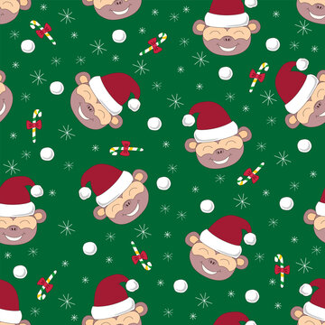 Cute seamless pattern with cartoon monkeys in Santa hats on green festive background.