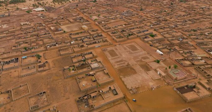 Vehicle Driving In Historic Town Of Ouadane In Adrar Region Of Mauritania. aerial orbiting shot
