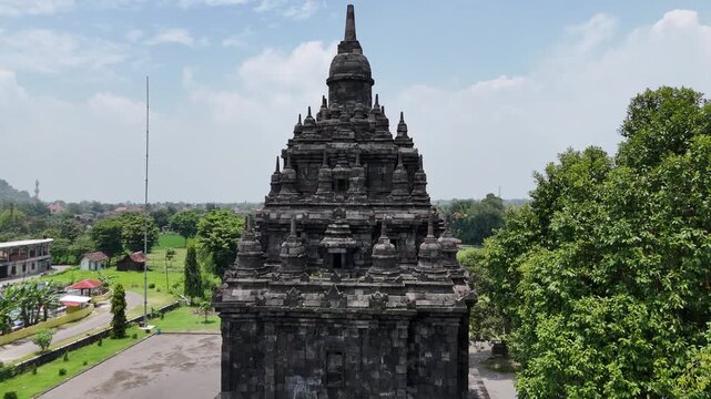 Drone pedestal up movement showing detailed stone structure of Sojiwan temple in Java