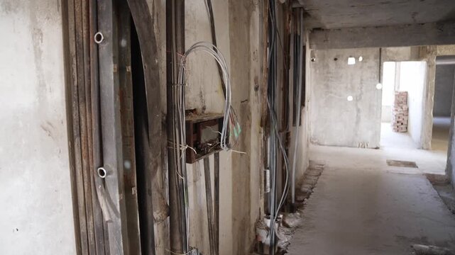 Old wiring in a concrete building during reconstruction. Replacement of electrical lines in a multi-storey building during renovation and repair.
