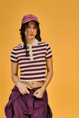 Young woman with pigtails showcases her style in a bright studio