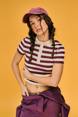 Young woman with pigtails looking at camera in a vibrant studio space