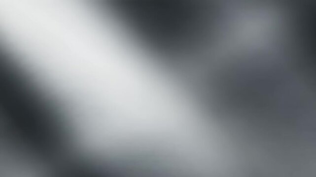 Dynamic silver-grey gradient background with a bright, ethereal diagonal light beam, perfect for modern digital displays, abstract video sequences, or futuristic graphic designs