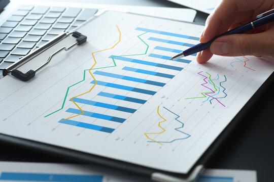 Business analysis reports with graphs. Statistical KPI data and financial results. Businessman analyzing performance and developing growth strategy.