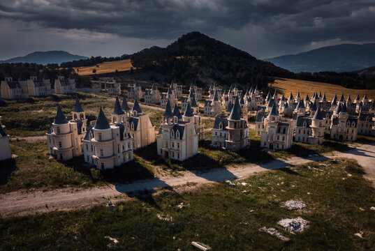 View of the abandoned Burj Al Babas castle houses nestled between forested hills under a dramatic cloudy sky in Dolayuz, Bolu, Turkiye.