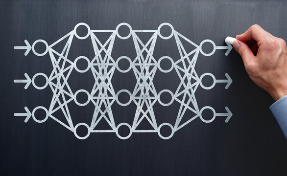 AI neural network. System engineer drawing neural connections and structure on blackboard. Analyzing machine learning and deep learning systems.