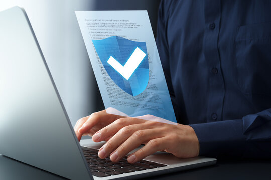 Approve and protect documents with document compliance management system. Legal file with check mark and shield icon. Businessman using laptop computer for checking contracts.