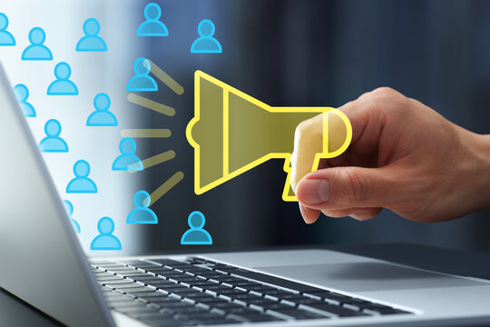 Digital marketing strategy and online campaigns. Social media promotion to audiences. Man holding megaphone icon next to laptop computer.