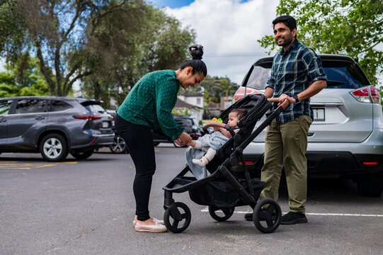 Parents with baby in stroller at parking lot