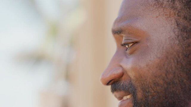 Black sprinter profile closeup face focused gaze after sprint, sweat on brow, warm sunlight, blurred palm background, resting between sets, measured breathing, quiet resolve and steady posture