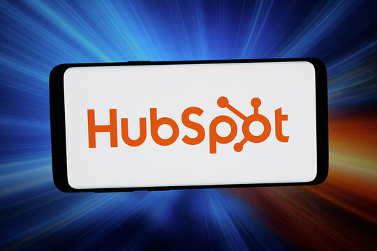 Stuttgart, Germany - 03-20-2026: In this photo illustration, the logo of US marketing software company HubSpot Inc. is displayed on a smartphone in front of abstract background on computer screen.