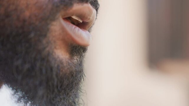 Dedicated sports person shares uplifting message. Motivational sports figure passionately speaks off camera. Committed athlete with friendly beard delivers encouraging and inspiring monologue