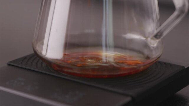 First drops of coffee falling into empty glass server