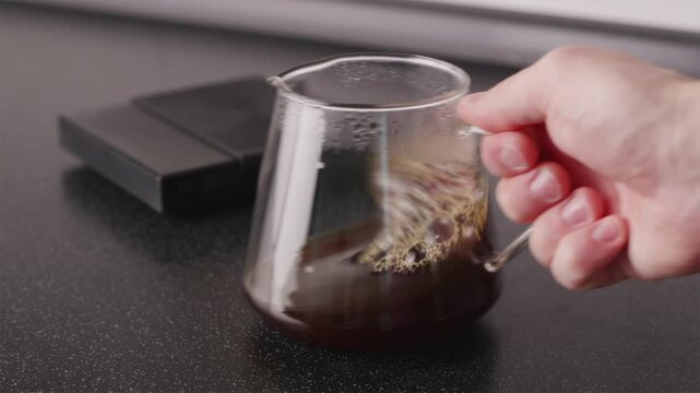 Wide shot of coffee aeration in server with scales in background