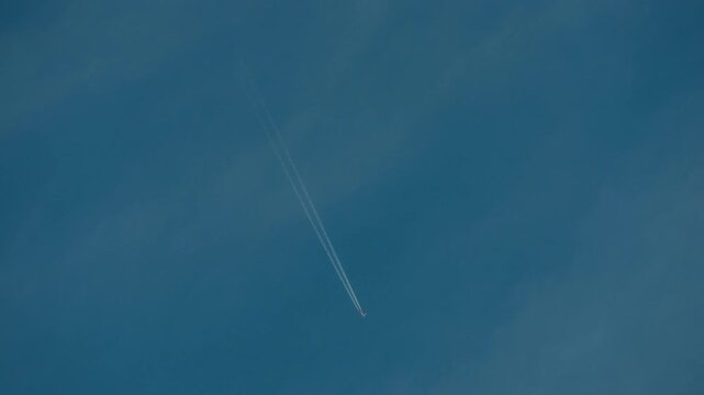 Jetliner crossing the sky creating contrails &nbsp;