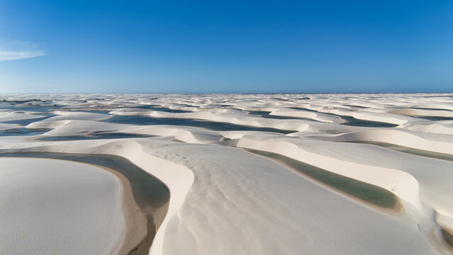 Aerial view of white sand dunes and freshwater lagoons in Lencois Maranhenses National Park, Brazil