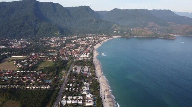 Aerial 4K wide view of Maresias beach coastline and mountains in Sao Sebastiao, Brazil