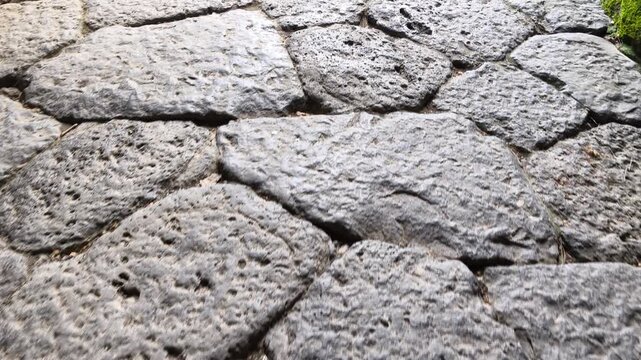 Herculaneum excavations featuring ancient polygonal paving stones of the Roman city destroyed by the eruption of Mount Vesuvius, preserved as a testament to historic urban design in Italy.