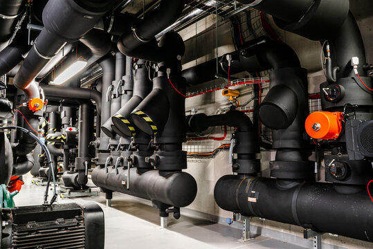 Industrial HVAC system with insulated pipelines and distribution units in plant room