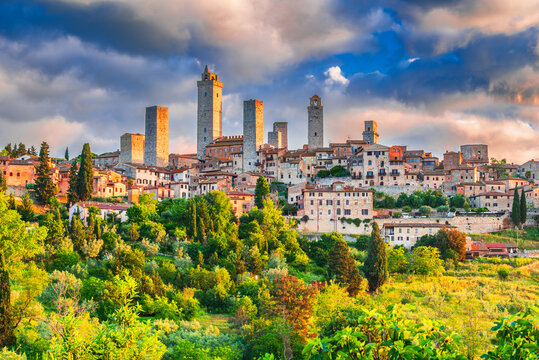 San Gimignano medieval town skyline and famous towers during sunrise - Tuscany, Italy.