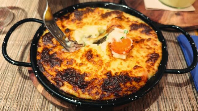 French style duck and potato casserole topped with melted cheese. Classic hachis parmentier with tender duck meat, creamy mashed potatoes, and crispy golden crust. High quality 4k footage